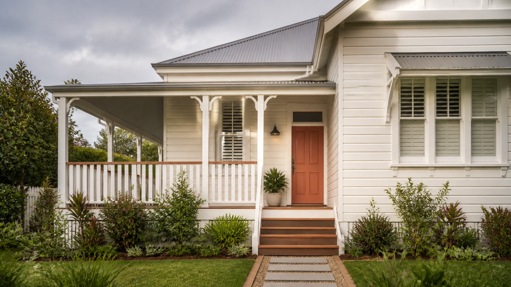 Illustrative freshly painted off-white Queenslander with terracotta door